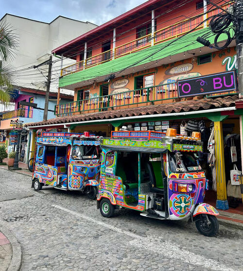 beautiful and very colorful busses in a day trip from guatape in the city