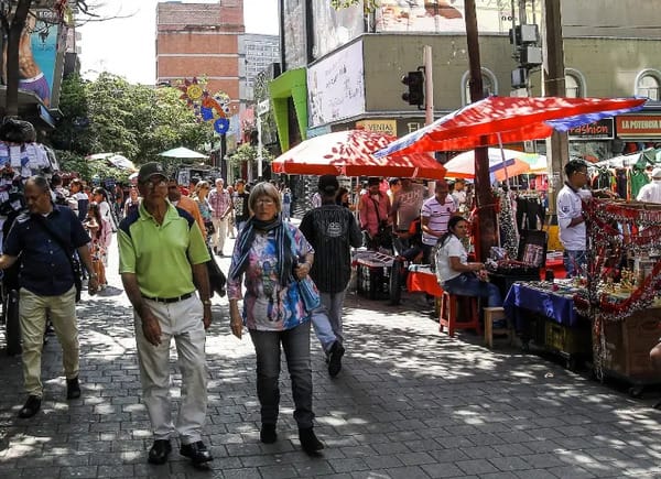 A bustling daytime street scene with locals and tourists, an important visual for anyone researching 'is safe Medellin' for daily activities and walking around.
