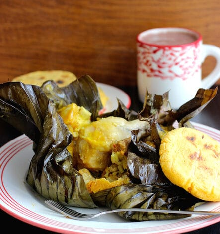A traditional Tamal Tolimense unwrapped from its plantain leaf, a hearty and complete Colombian breakfast often served with hot chocolate.