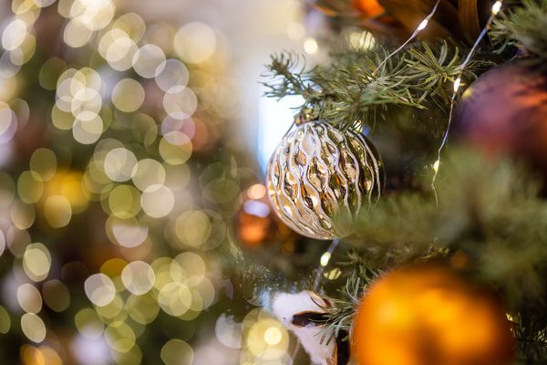 Close-up of a Christmas tree ornament and bokeh lights, festive home decor inspired by christmas traditions colombia